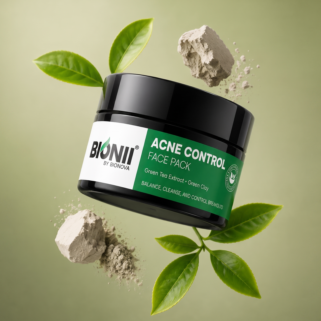 Acne Control Face Pack – Green Tea Extract & Green Clay | Balances, Cleanses & Controls Breakouts. BIONII ACNE CONTROL FACE PACK, floating against a soft olive-green background with green leaves and powder clouds around it.